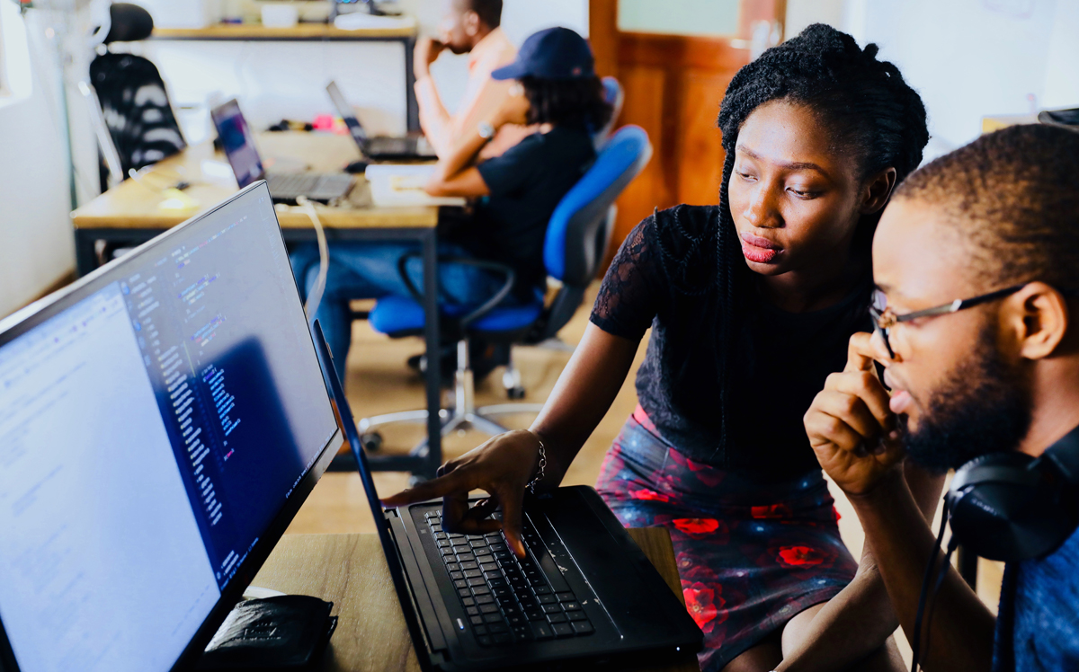 Two people working on a computer in a cool study spot on campus