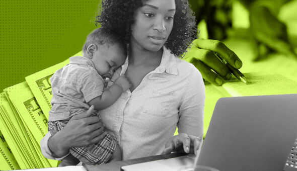 student parent holding a child while working on a laptop