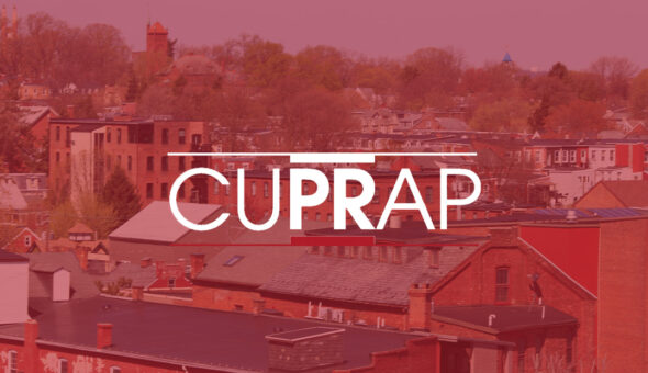 Graphic design showing an image of a small town with a reddish overlay and the acronym in all caps CUPRAP in the center in large white text.
