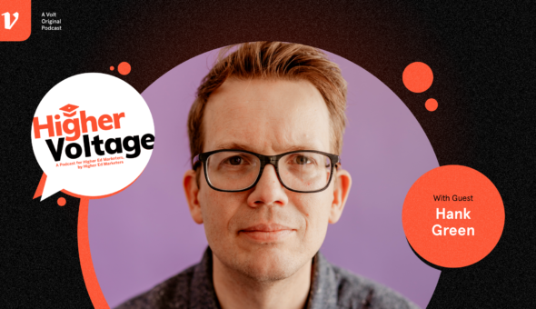 Graphic design with a black background and a bubble with an orange rim; inside the bubble is a picture of a man with light skin, light hair, and glasses, looking straight out at the viewer. Two bubbles next to this one say 'Higher Voltage' and 'with guest Hank Green.'