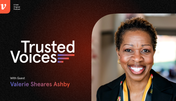 Graphic design showing a black-orange background next to a picture of a woman with dark skin, brown hair, and a black-colored suit jacket with a yellow scarf; the word Trusted Voices appears on the background; beneath that is the name 'Valerie Seares Ashby.'