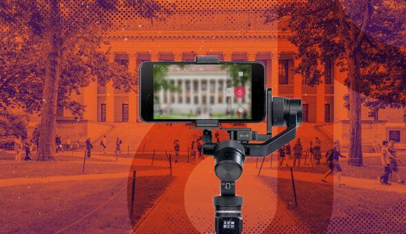 A camera on a tripod filming a tiktok challenge on a university campus