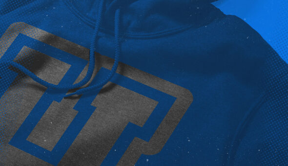 A close-up image of a blue hoodie with a gray university logo on it.