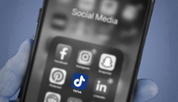 A phone showing social media icons, including TikTok.