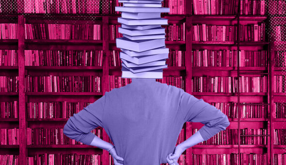 Unveiling the Fiscal Challenges for UK Higher Ed article image, a person standing in a library or bookstore surrounded by shelves filled with pink or reddish-colored books. The person's head is obscured by a stack of white books balanced on top.