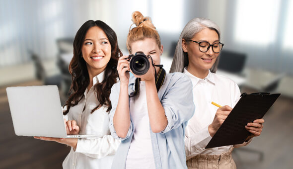 "Breaking the one-size-fits-all trap by optimizing higher ed marketing, pr and communications for success." article image. Three women in a professional setting, each representing different roles: one on the left holding a laptop and smiling, the middle woman holding a camera up to her eye as if taking a photo, and the woman on the right with gray hair and glasses writing on a clipboard. The background shows a blurred office environment.