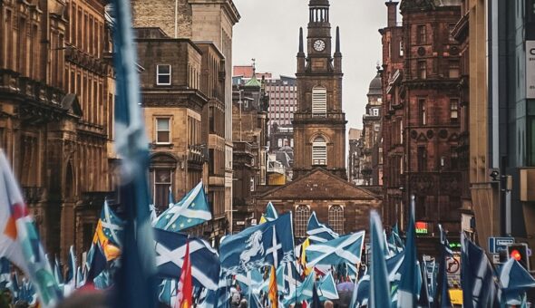 A crowd of Scotland fans carrying Scottish flags